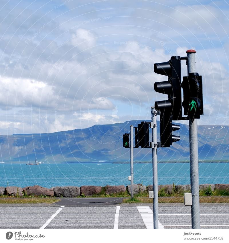 Open road for Icelanders Pedestrian lights Street Green Sky Clouds Ocean Landscape Nature Beautiful weather Summer green traffic light Environment Authentic