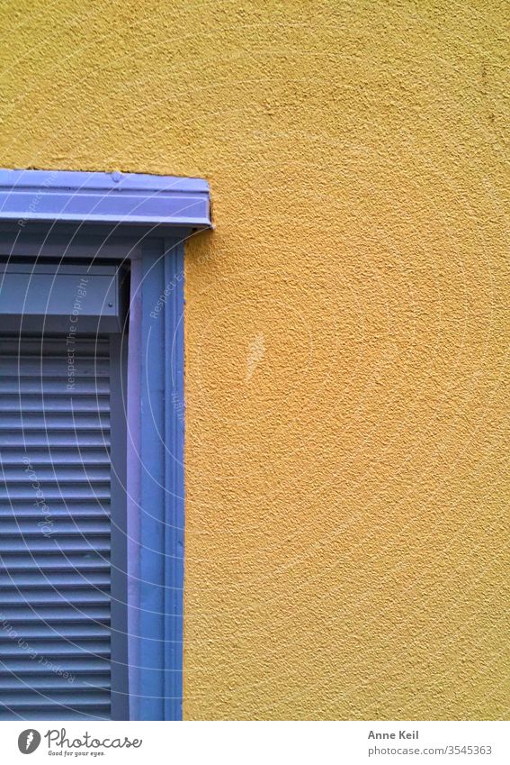 Blue shutter on yellow wall. She liked the color combination and found it again and again. Front view Central perspective Day Deserted Exterior shot