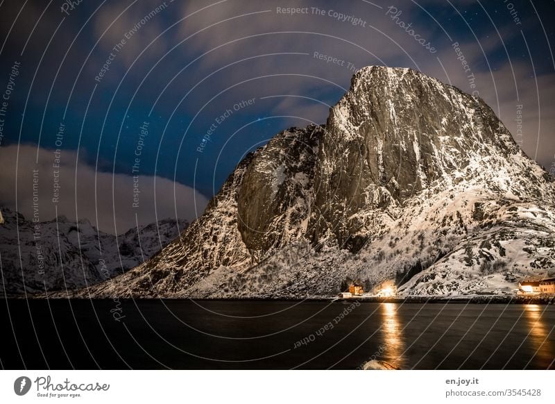 Mountain covered with snow at the blue hour mountain Snow Night Winter Fjord Reine Reinefjorden Hamnøy Starry sky Clouds Long exposure Vacation & Travel Norway