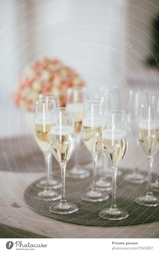 glasses with champagne stand on the table creating a festive mood, festive background, copy space for text,  copy space , vertical alcohol banquet bar beautiful