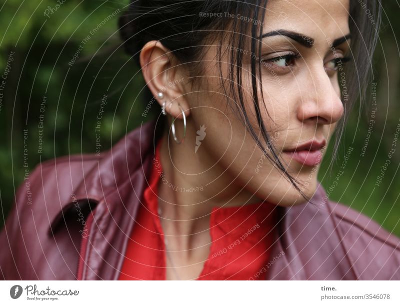 A view from up close Woman portrait Half-profile Jacket look Skeptical earring Black-haired Long-haired braid critical