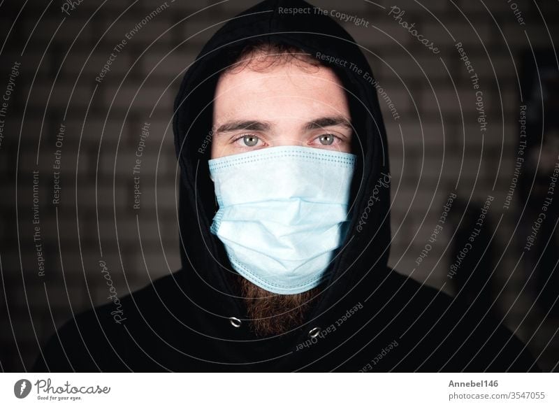 Portrait of young man wearing medical protective face mask for Covid-19 Coronavirus concept. Protect your health. background covid-19 business person fitness