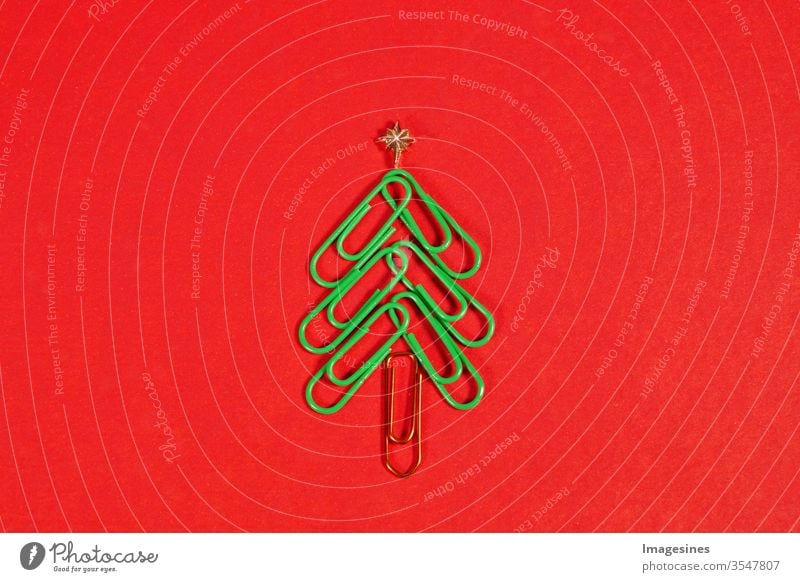 Merry Christmas at the office. Christmas tree made of paper clips on the red background. Paperclip Christmas tree. Christmas background. Copy Space right
