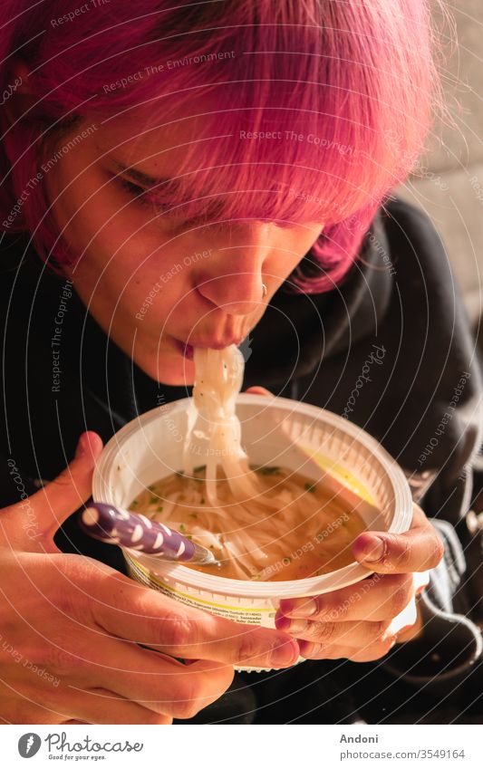 Girl with pink hair eating noodles Human being Youth (Young adults) Hair and hairstyles Full Colour photo Slaver Meal Noodles Appetite Adults Young woman