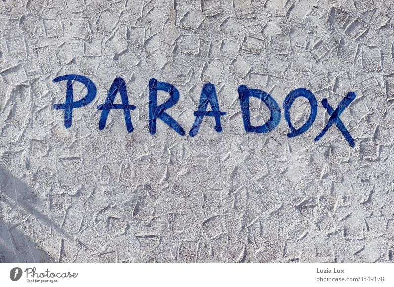 Paradox - Graffiti on a wall with plaster, sunlight and shadow Wall (building) Street dreariness Town urban Exterior shot Deserted Day Facade Wall (barrier)
