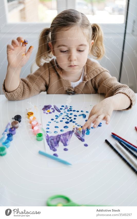 Little girl using gouache for drawing with fingers on paper at home child paint kindergarten creative kid cute education pencil learn elementary little adorable