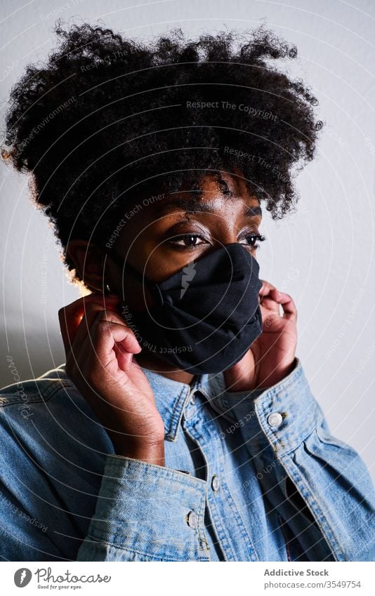 Young black woman in protective mask coronavirus stay home covid young african american ethnic female afro casual safety support caution covid 19 contemporary