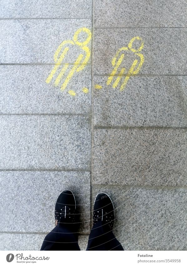 Keep your distance! - or two yellow stick figures painted on the floor indicate the distance rule Footwear feet Human being Stand Exterior shot Colour photo Day