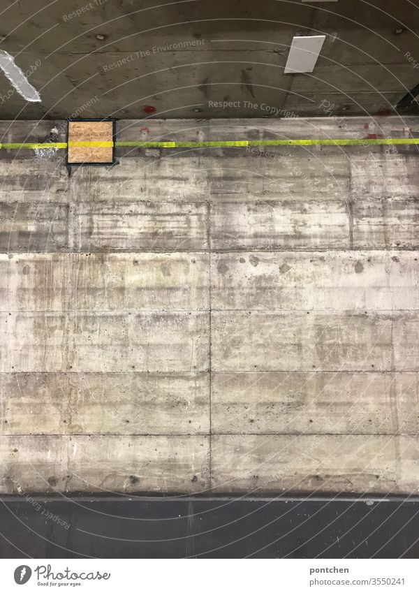 Concrete wall, ceiling and floor. Subsoil. Dirty. Neon yellow line on the wall. Cold, dark, scary. Room Wall (building) Ground Ceiling chill somber Eerie peril