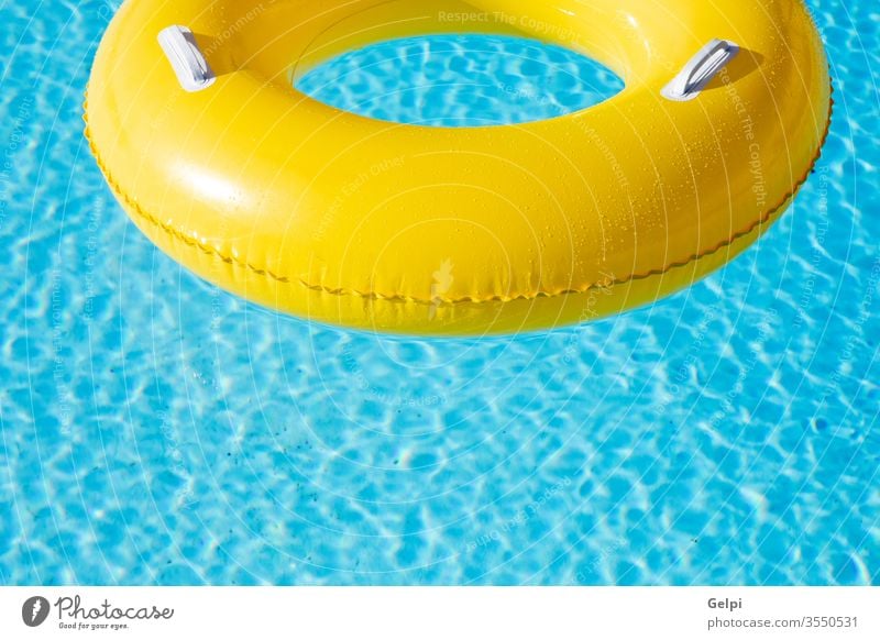 Yellow big float on pool resort blue water yellow nobody ring fun swim inflatable tropical travel summer hotel empty rubber wave space sun toy reflection