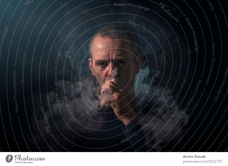 portrait of a man with vaporizer and smoke background beard black blowing blur cigarette cigarettes confident cool e-cigarette ecig electronic equipment