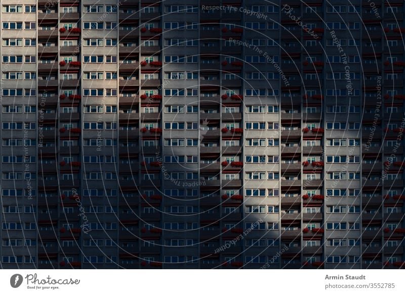 architectural pattern,  facade of a skyscraper with balconies and flower box in the night anonymity anonymous architecture background balcony big block building