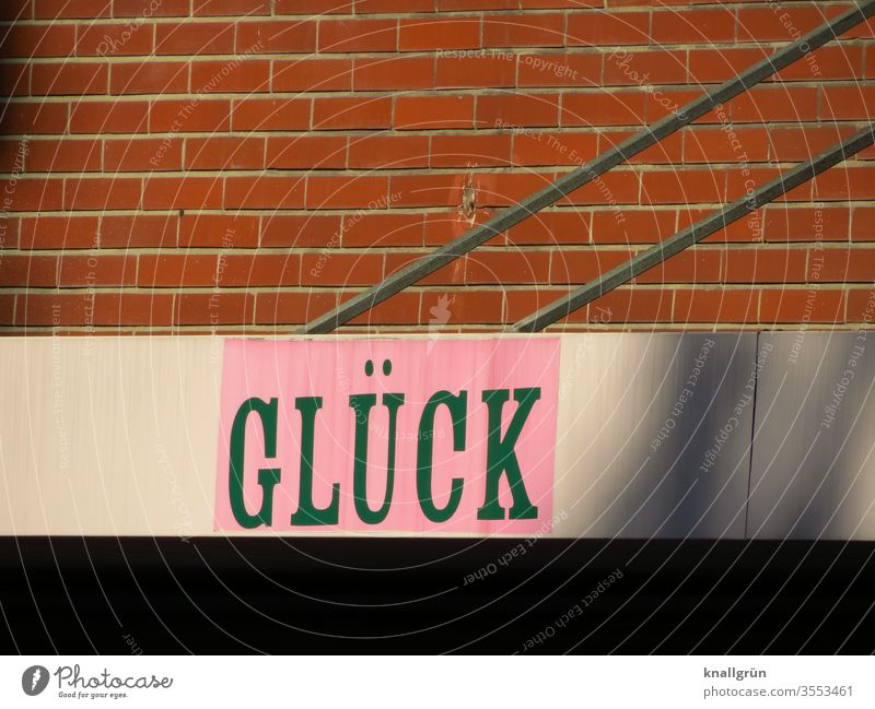 Advertising, the word "GLÜCK" placed above a retail shop luck Characters Typography Letters (alphabet) Signs and labeling Signage Word Text Communicate Language