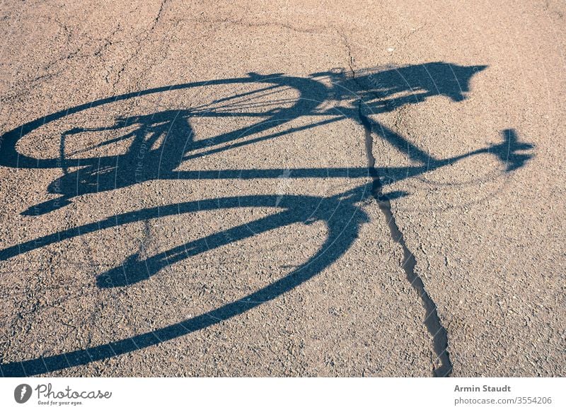 shadow of a bicycle on the street cycling outdoor biking activity lifestyle asphalt bike city leisure nature old outdoors outside pedal road silhouette sport