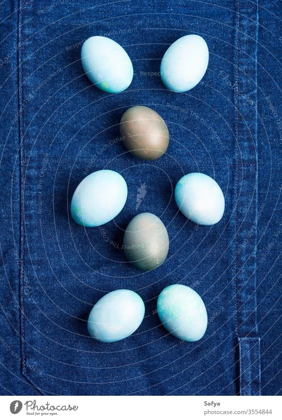 Easter boiled eggs as bunny symbol on blue easter pastel color jeans textile holiday spring design food hen hard flat lay background decor copy space celebrate