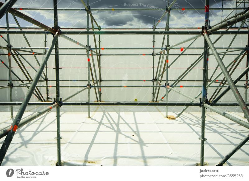 Construction with shade during approaching thunderstorm clouds Scaffold tarpaulin Shadow Sunlight Silhouette Structures and shapes Raincloud
