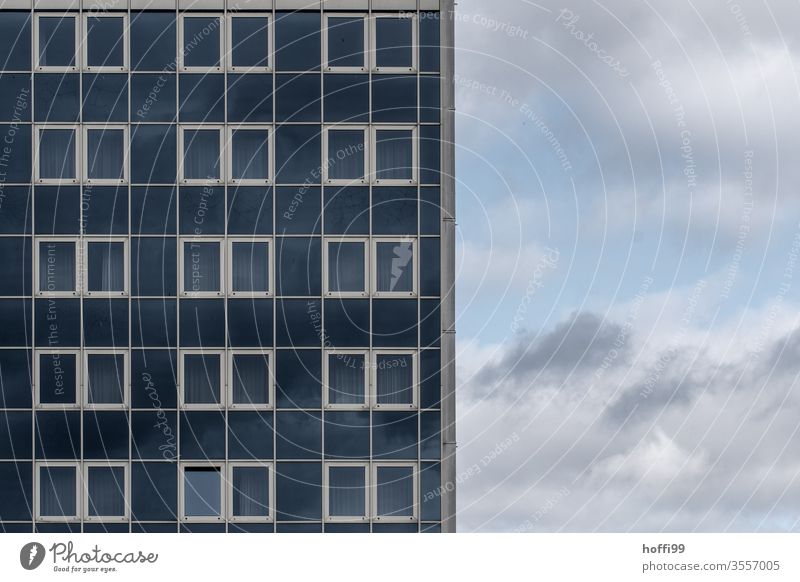 monotonous prefabricated building facade with clouds High-rise Bank building Facade Window Symmetry Esthetic Arrangement Glass Geometry Surface