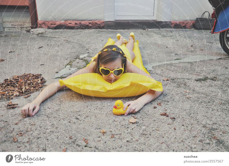 girl lies on air mattress in the backyard | holidays at home vacation Youth (Young adults) teenager Mattress Bikini Sunglasses Squeak duck Courtyard Backyard