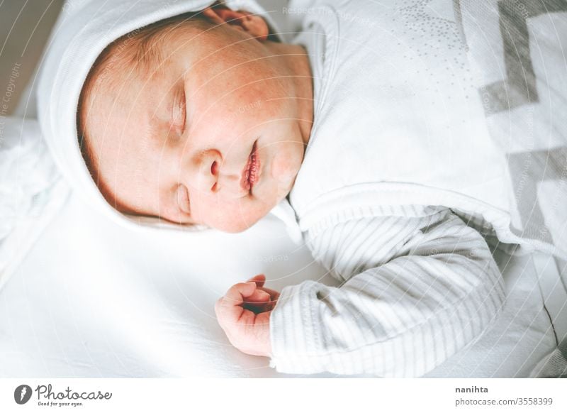 Little baby girl in her first days of life new born birth boy hospital room mom familly happy happiness care love child daughter son tired sleep sleeping dream