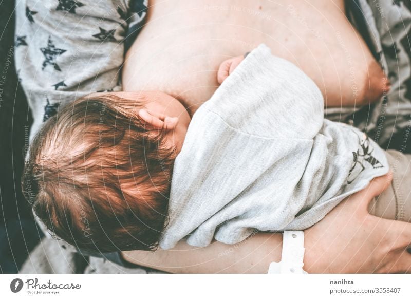 Close up of a young mother breastfeeding her little baby breast-feeding mom motherhood new born birth food eat eating head closeup close-up health healthy life