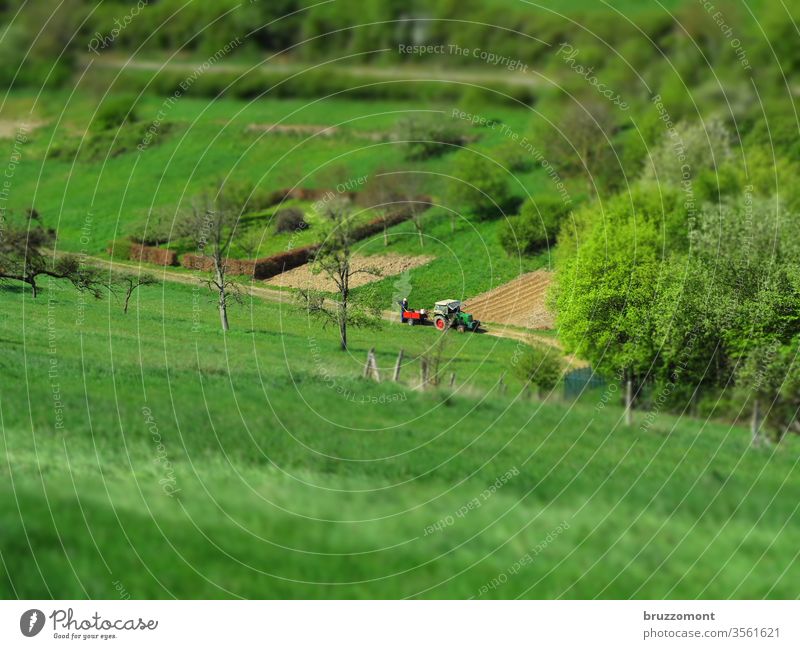 Tractor on the field Tilt-Shift Agriculture Field Valley Meadow huts spring peasant Nature