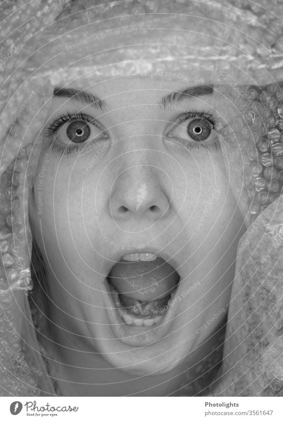 Young woman surprised or startled? Scream 18 - 30 years Interior shot Fear Panic peer big eyes Teeth Mouth Mouth open Face portrait Nose Lips Human being Eyes
