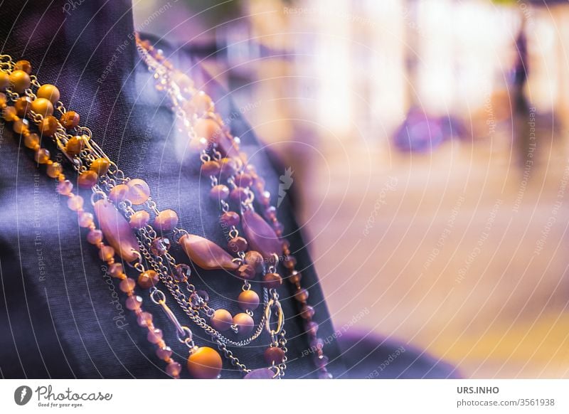 Bust with a multi-row amber necklace Necklace necklaces chains Blur purple Orange Jewellery SHOPPING Amber Gemstone Close-up Minerals Resin Colour photo