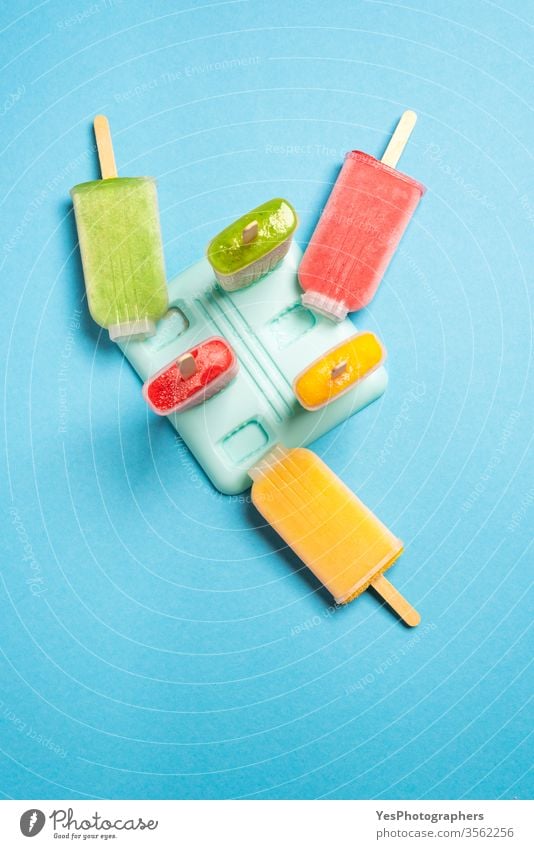 Popsicle ice cream homemade with fruits, above view blue background colorful delicious dessert detox diet diversity flat lay flavor food freeze frozen green