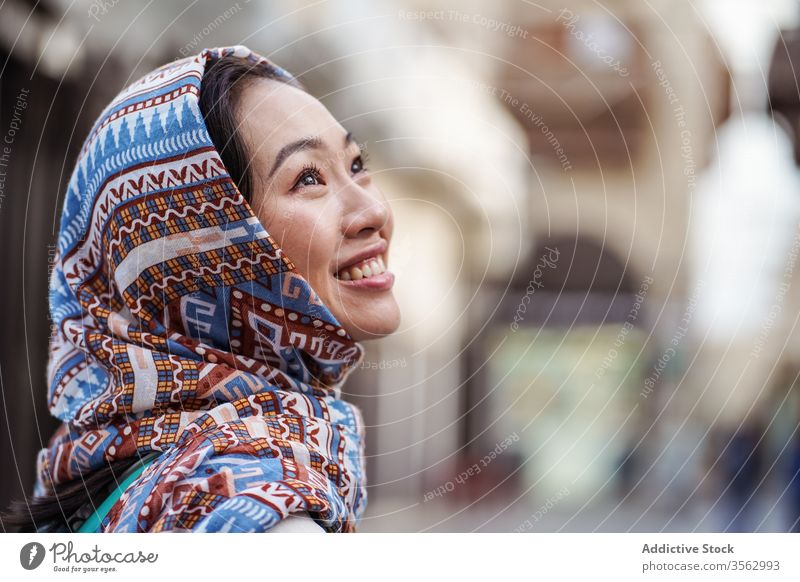 Positive ethnic woman in city district street young smile happy headscarf positive saudi arabia jeddah east asian female urban cheerful joy glad modern local
