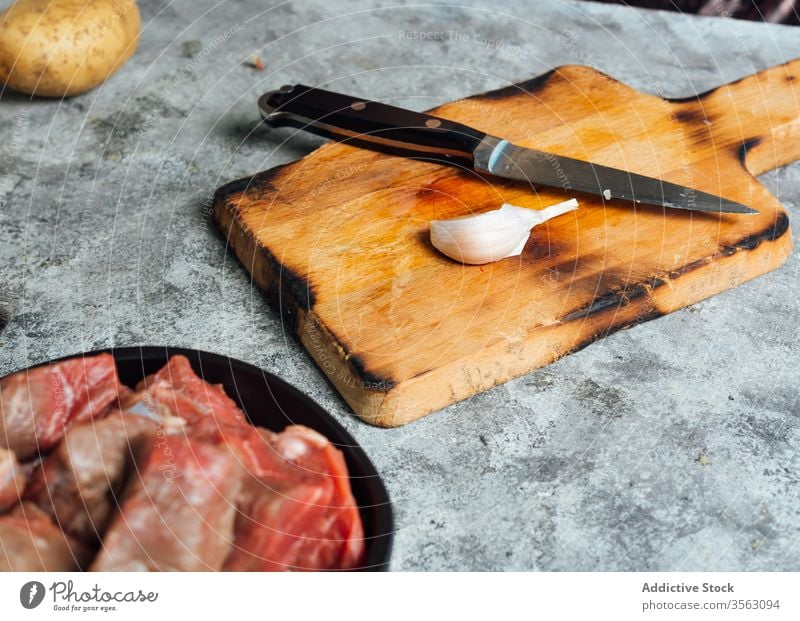 Garlic clove on cutting board in kitchen garlic knife fresh meat chopping board table raw bowl beef food uncooked prepare cuisine culinary dinner nutrition
