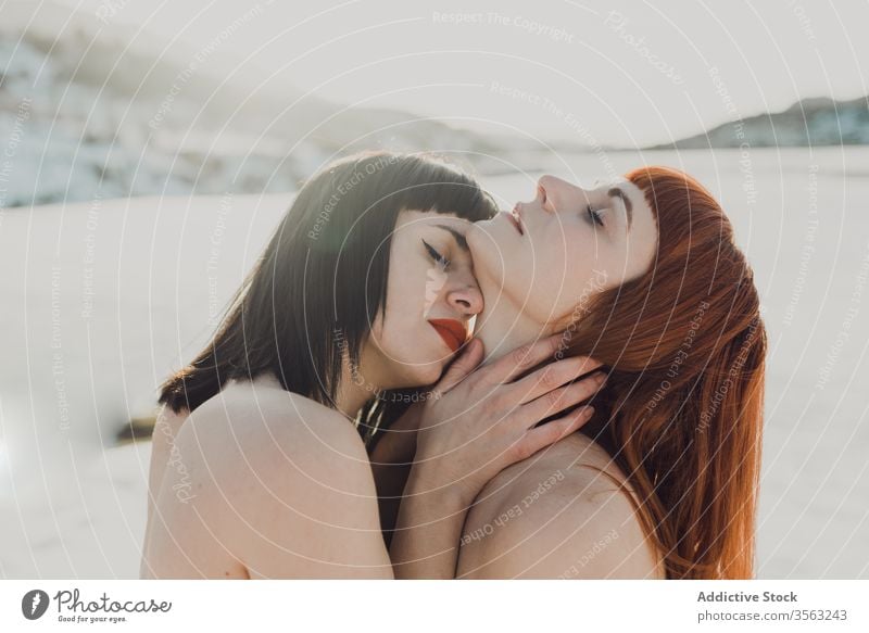 Tender lesbian couple in sunny winter field women love sensual touch allure lgbt tender together nature same sex embrace enjoy freedom passion kiss relationship