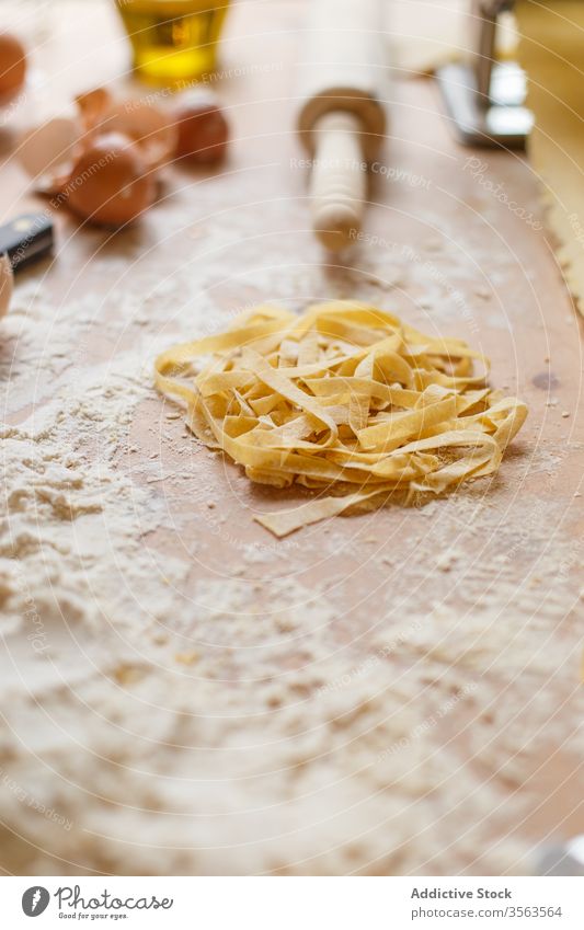 Composition of pasta and kitchenware on table raw flour utensil various shape dough pastry messy make device cookery prepare food spoon daylight gastronomy