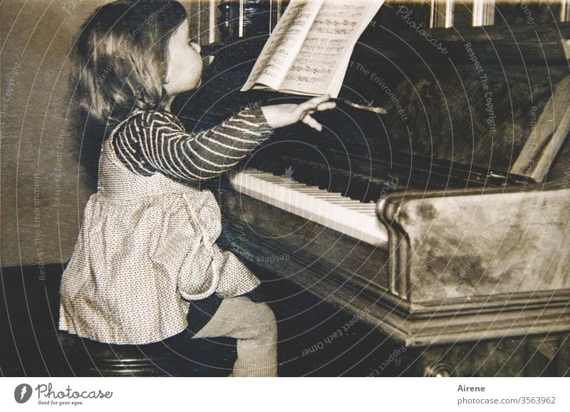 It can't be that hard. Piano Girl old photo Play piano Pianist fifties Musician Child Toddler piano lesson piano player Keyboard instrument Playing the piano