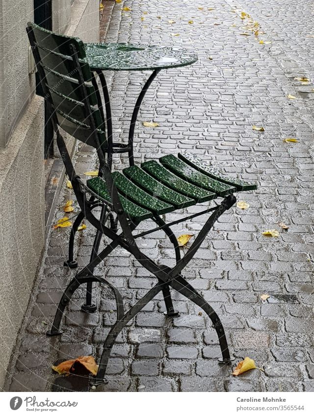 Green bistro chair and table left in the rain Chair Table Bistro table Living or residing Colour photo Day Deserted Exterior shot Furniture Decoration Esthetic