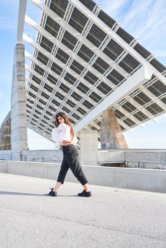 Woman dancing on modern building woman dancer ballerina contemporary concept high concrete person urban fly female construction street motion architecture