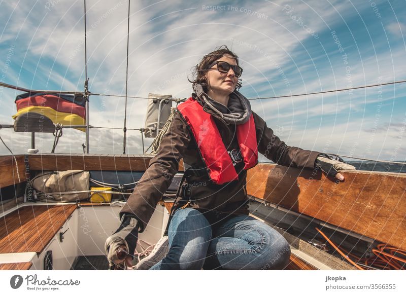 Young woman sailing on the Baltic Sea Sailing Woman boat yacht Yacht Sailboat Adventure Water vacation ship Nautical travel Sailing ship Exterior shot Deck