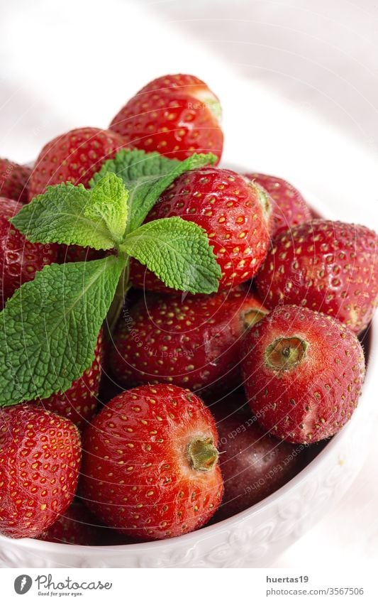 Healthy and fresh strawberries in bowl with mint fruit red organic strawberry food vitamin closeup background healthy sweet freshness summer vegetarian diet