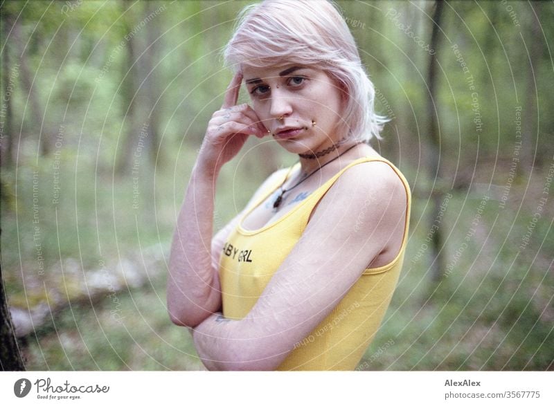 Analogue portrait of a young woman with piercings, tattoos and tunnel Woman girl Blonde Piercing Jewellery Assecoires Shoulder shirt Shirt already out look