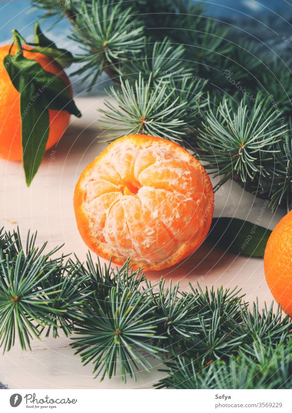 Fresh tangerines on white rustic board winter christmas background new year branch symbol cook ingredient green tree fir spruce wooden fruit clementine top view