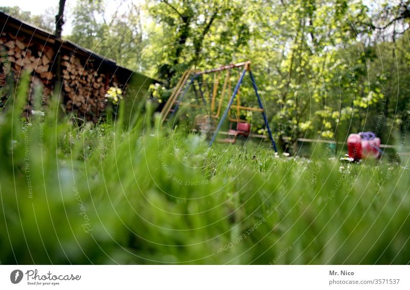 in the garden Garden Meadow Lawn Grass green Summer Nature Plant Garden plot Swing To swing Playing Worm's-eye view Relaxation Idyll Stack of wood Seesaw