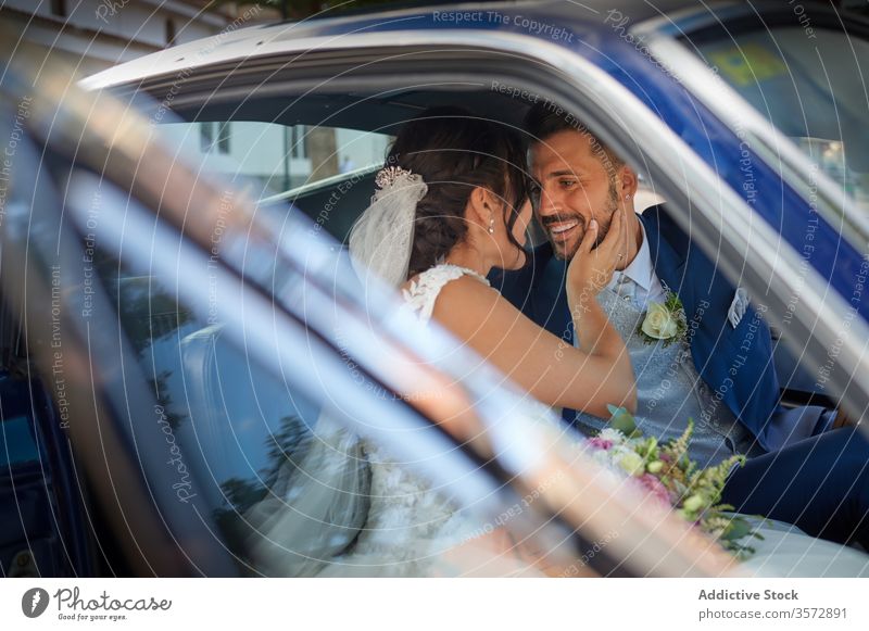 Delighted newlywed couple in luxury car bride groom wedding dress classy suit happy delight smile cheerful content sit vintage retro automobile shiny tuxedo