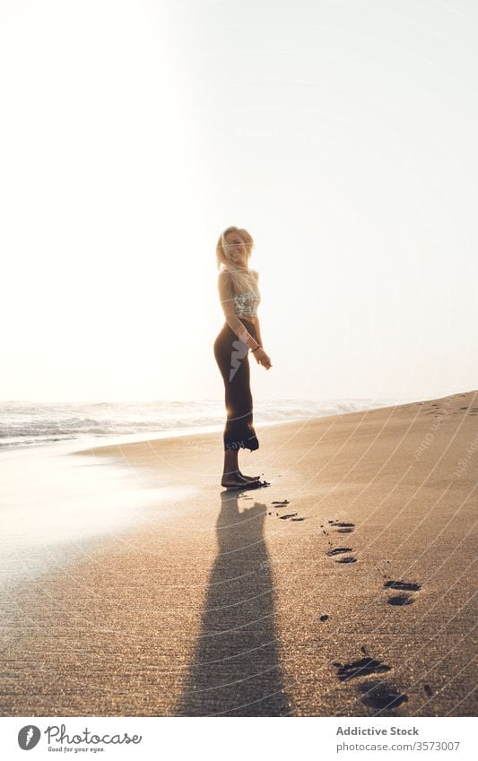 Slim young female standing on wet sandy beach woman seascape harmony solitude peace wave hipster alone coast calm sensual romantic freedom water summer barefoot