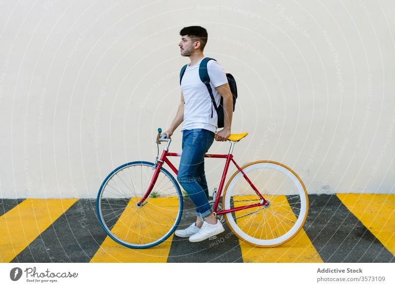 Caucasian man riding a fixie bicycle bike urban wheel fixed sport transportation gear lifestyle wall street hipster ride pedal biking chain action cyclist