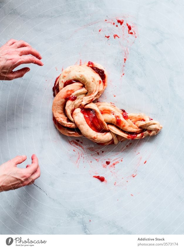 Anonymous person making fresh strawberry brioche on a marble table fruit preserve hands butter flour filling pastries sweet food sugar filled jam kitchen oven