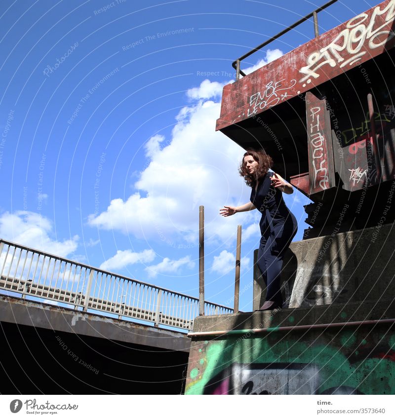 special stage Woman Stand jump bridge Concrete graffiti Sky sunny Clouds Shadow Dynamic Manmade structures Wall (building) actress Handrail