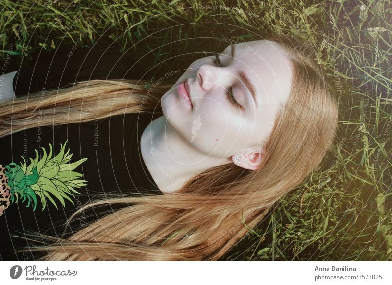 Pretty girl laying in the grass Portrait photograph portrait Woman Face Young woman Beautiful Nature