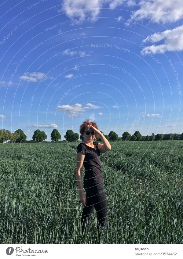 Woman in the field Field Summer Looking into the camera 30 - 45 years Sunglasses summer blue Blue sky Trip Adults Colour photo 1 Feminine Exterior shot Nature