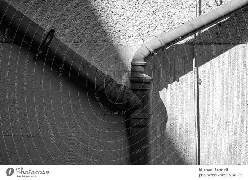 Water pipes on a house wall Wall (building) Deserted Facade built House (Residential Structure) Detail Gray Black & white photo Shadow