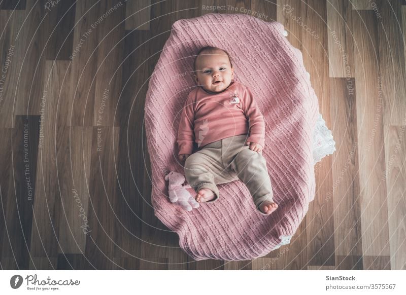 Cute baby lying in the basket, top view. bed white little cute newborn home young child infant kid childhood adorable beautiful pink healthy crib happy care