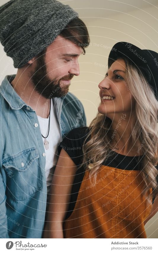 Happy couple embracing standing in the kitchen at home embrace relationship positive hipster style boyfriend affection fondness together love girlfriend partner